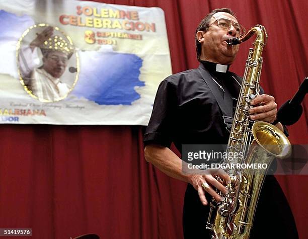 The Honduran Cardinal Oscar Rodriguez Maradiaga plays the saxophone during a sing along with young children 8 September 2001 in Soyapango, El...
