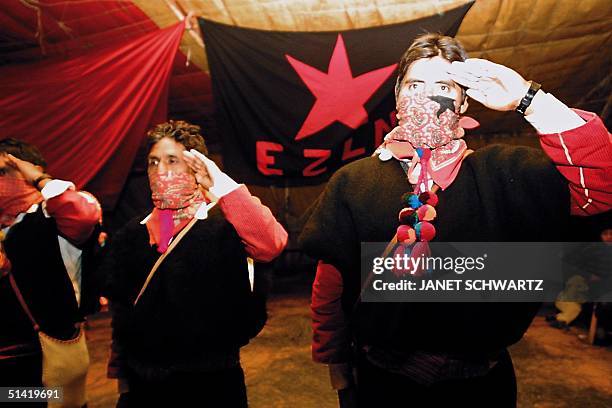 Rebel fighters salute the flag in Chiapas, Mexico 01 January 2002. Autoridades de diversos municipios aut=nomos rebeldes de los Altos de Chiapas,...