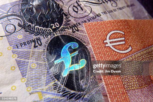 Detail of a twenty Pound bank note with with hologram design and a ten Euro note, on March 7, 2016 in London, England.