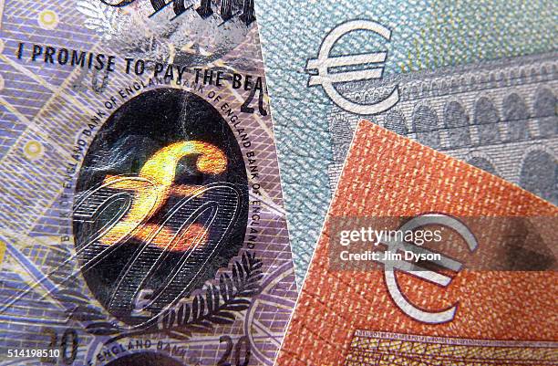 Detail of a twenty Pound bank note with hologram design and a five and ten Euro note, on March 7, 2016 in London, England.