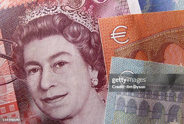 Detail of a fifty Pound bank note showing a portrait of Queen Elizabeth II and a five and ten Euro note, on March 7, 2016 in London, England.