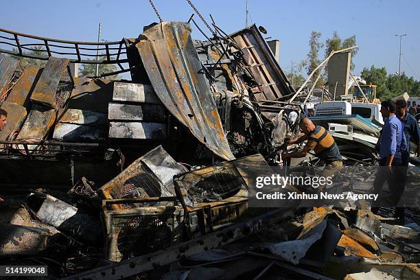 March 6, 2016: People gather at the site where a suicide truck bomb hit a crowded security checkpoint in northern Hilla city, Iraq, on March 6, 2016....