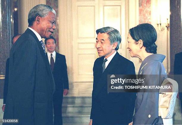 South African President Nelson Mandela speaks with Japanese Empero Akihito and Empress Michiko as he receives a farewell call by the royal couple at...
