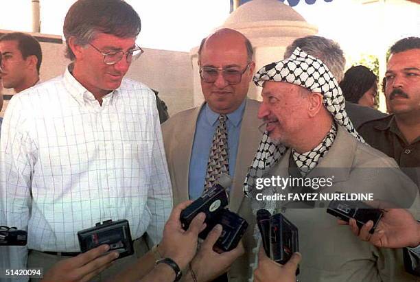 Palestinian leader Yasser Arafat and US Middle East envoy Dennis Ross during a joint press conference 29 August in front of Arafat's office in Gaza...