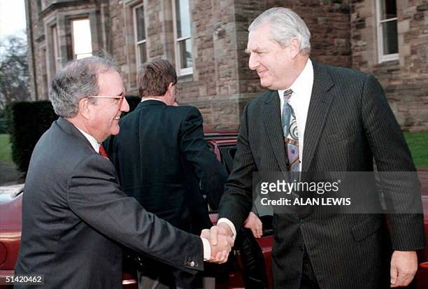 Senator George Mitchell , head of the International Arms Commission, greets Northern Ireland Secretary of State Sir Patrick Mayhew 15 December on his...