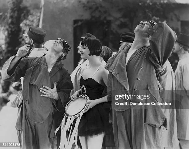 Actress Louise Brooks and a actors in a scene from the movie "Now We're In The Air" which was released in 1927.