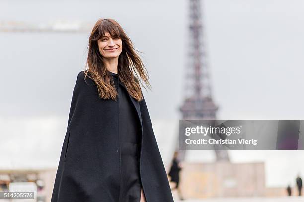 March 07: Caroline de Maigret wearing a long black cape and dress posing in front of the Eifel Tower outside Sacai during the Paris Fashion Week...