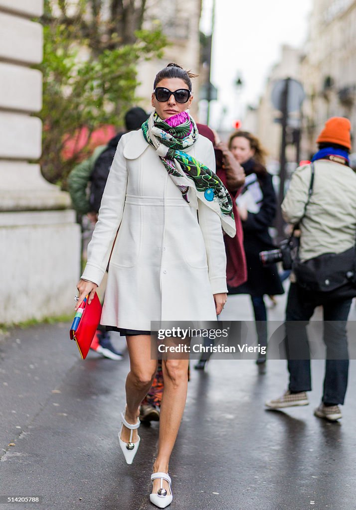 Giovanna Battaglia wearing a white coat and scarf with floral print ...
