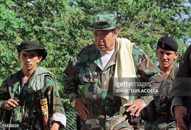 Manuel Marulanda "Fixed Shot" , chief leader, along with other unidentified members of the Revolutionary Armed Forces of Colombia participates in an...
