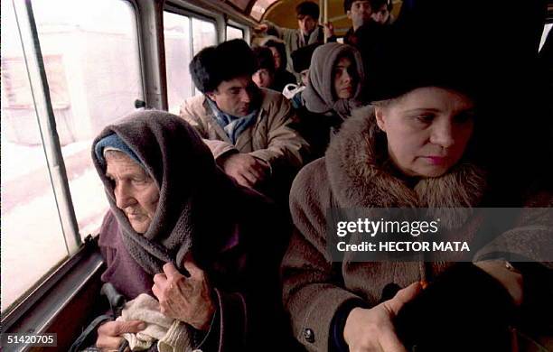 Group of refugees leave Grozny, Chechnya, 26 December, on a bus as hundreds of civilians continue trying to find refuge in Daghestan and other...