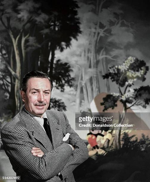Entrepreneur Walt Disney poses for a portrait with Mickey Mouse in the background in circa 1955.