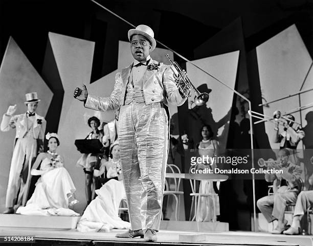 Musician Louis Armstrong holds his trumpet as he performs in a scene from the movie "Dr. Rhythm" which was released in 1938.