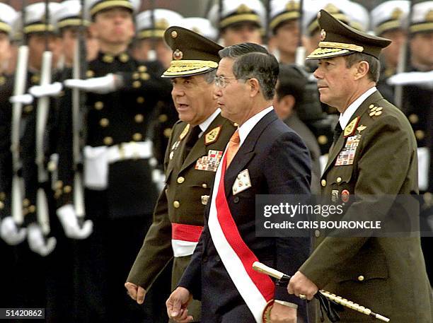 Peruvian President Alberto Fujimori walks past troops in Lima, Peru, who were participating in his inauguration ceremonies, 28 July 2000. Fujimori is...