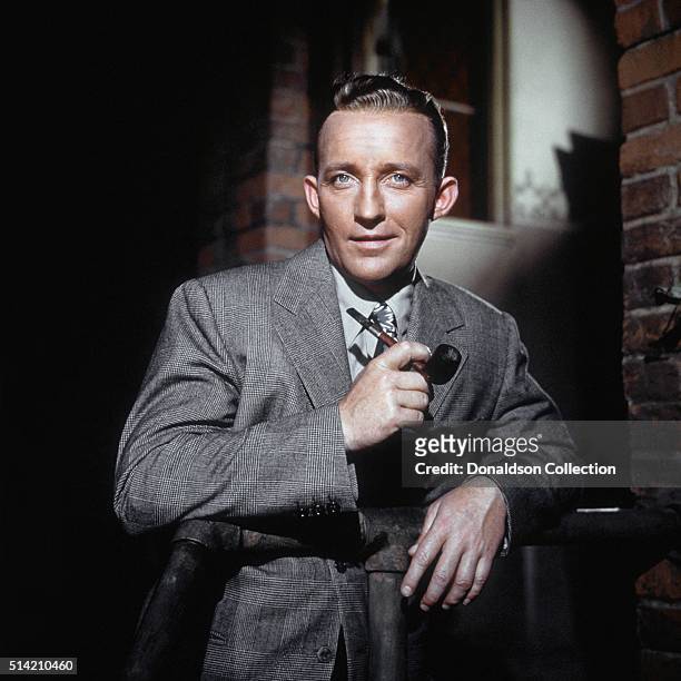 Actor Bing Crosby poses for a portrait with pipe in circa 1950.