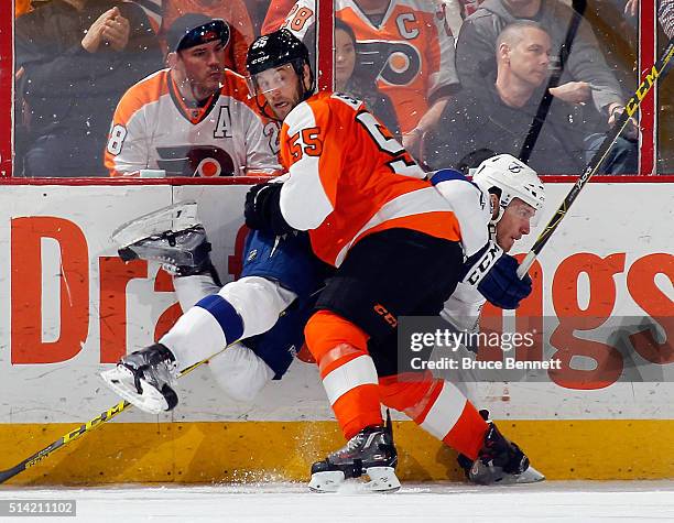 Nick Schultz of the Philadelphia Flyers checks Slater Koekkoek of the Tampa Bay Lightning into the boards during the second period at the Wells Fargo...