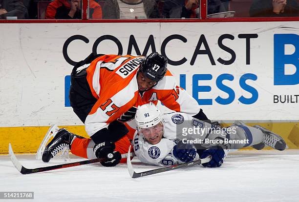Steven Stamkos of the Tampa Bay Lightning is checked by Wayne Simmonds of the Philadelphia Flyers during the second period at the Wells Fargo Center...