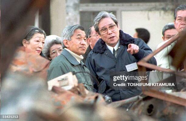 Kobe Mayor Kazutoshi Sasayama describes earthquake damage to Japanese Emperor Akihito and Empress Michiko 31 January 1995 as they visit the site of a...