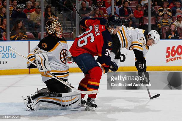 Jussi Jokinen of the Florida Panthers upends John-Michael Liles in front of goaltender Tuukka Rask of the Boston Bruins during first-period action at...
