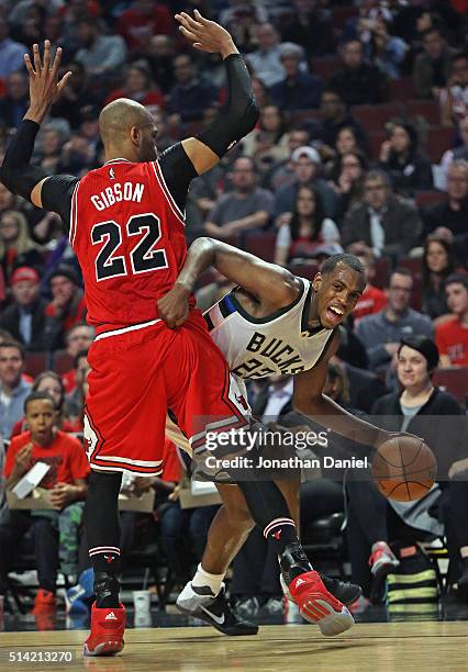 Khris Middleton of the Milwaukee Bucks tries to get around Taj Gibson of the Chicago Bulls at the United Center on March 7, 2016 in Chicago,...