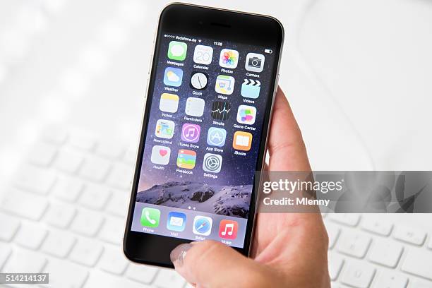 woman holding apple iphone 6 - ios greece stock pictures, royalty-free photos & images