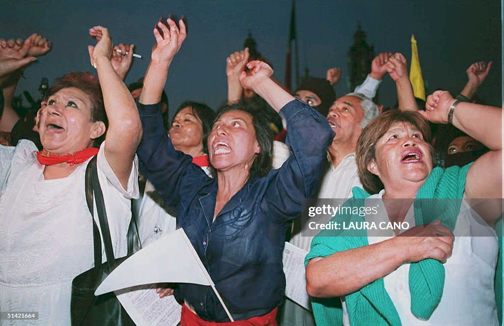 Women shout anti-government slogans as they join w