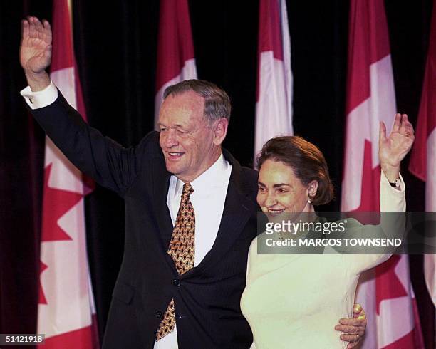 Canadian Prime Minister Jean Chretien and his wife Aline wave to supporters after he delivered an acceptance speech as his Liberal party maintained...