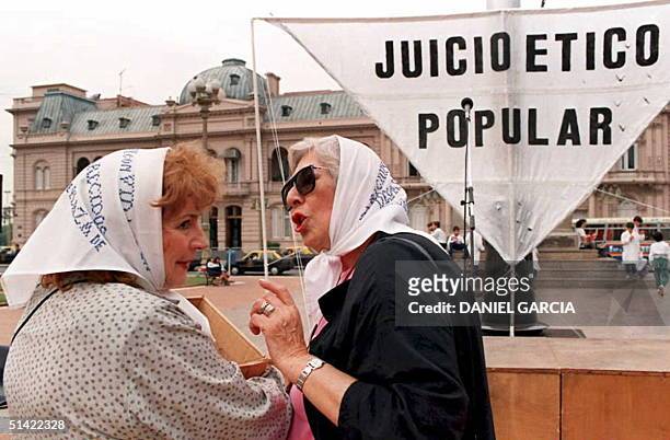 Two members of the "Mothers of Plaza de Mayo" movement chat in front of the Government Palace 04 May during a rally in Buenos Aires marking the 18th...