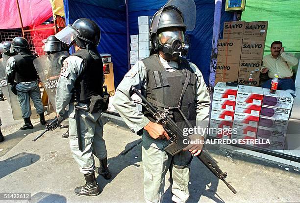 Federal Preventive Policemen guard part of a seizure of electronic appliances after a police operation in which 40 people were arrested for smuggling...