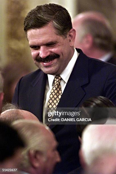 New Argentine Economy Minister Ricardo Lopez Murphy is greeted by government employees after taking oath 05 March 2001 in the Government House of...