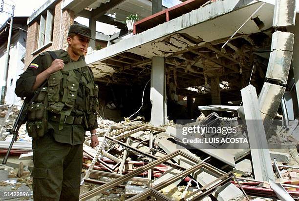 Policeman walks through the rubble of a building on a street of Arbelaez, 70kms southwest of Bogota, Colombia, 19 June, 2001. Un policia camina entre...