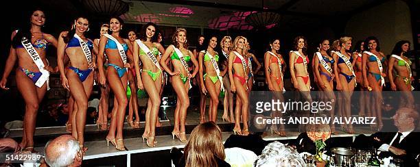 Candidates stand during the bathing suit competition to choose the new Miss Venezuela as they march past memebers of the media and judges in a hotel...