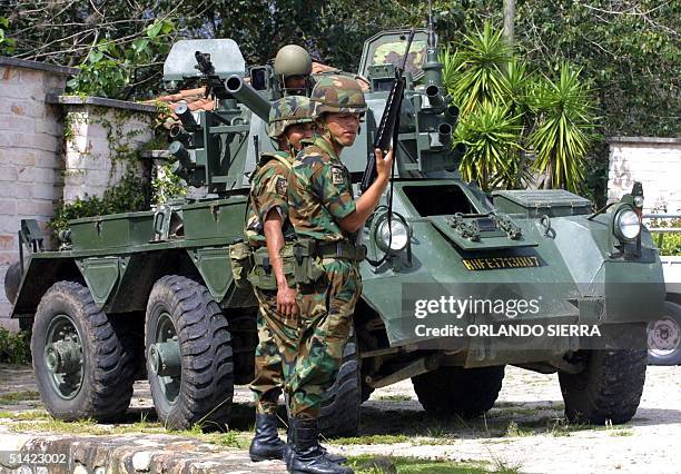 Tanks and soldiers guard the front of the Panamerican School of Agriculture where central American leaders meet in order to sign an accord against...