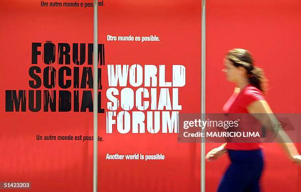 Student walks by a sign advertising the World Social Forum in Porto Alegre, Brazil 28 January 2002. Una estudiante camina, el 28 de enero de 2002,...