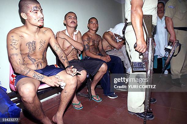 Injured prison gang members wait for medical aid 19 February at a local hospital in Santa Ana, El Salvador, after a gang fight broke out at the...