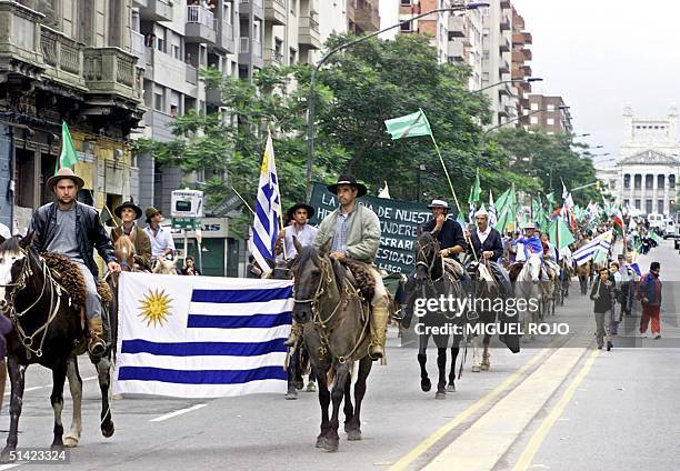 Thousands of protesters march 16 April in Montevideo during a demonstration called "Because Another Uruguay is Possible." The march was called for by...