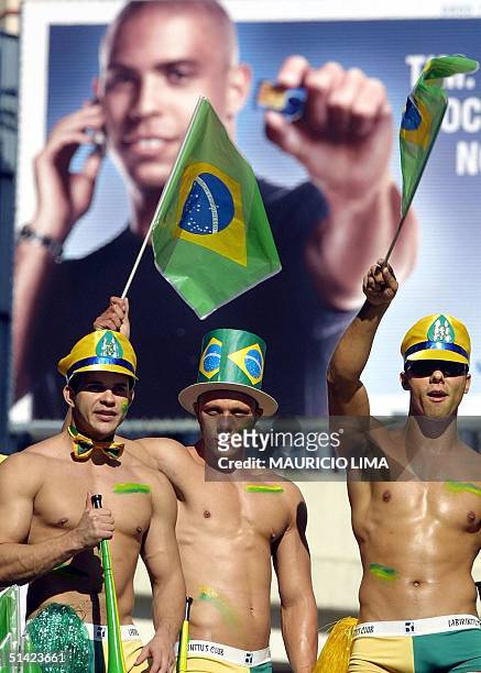Homosexuals are seen marching with Brazilian flags in front of a billboard with Brazilian soccer player Ronaldo, 02 June 2002, during the GLBT Gay...