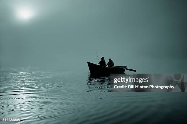 rowboat fishermen silhouette - bateau à rames photos et images de collection