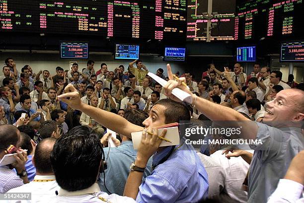 Stock market operators negotiate trades in Sao Paulo, Brazil, 31 July, 2002. The real hit a record low 30 July when it fell to 3,30 to the dollar,...