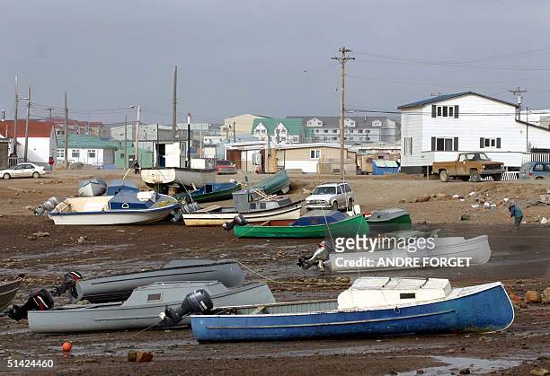 Fishing boats rest on the shore of Frobisher Bay in Iqaluit, Nunavut, Canada 05 October, 2002. Britain's Queen Elizabeth II and her husband, Prince...