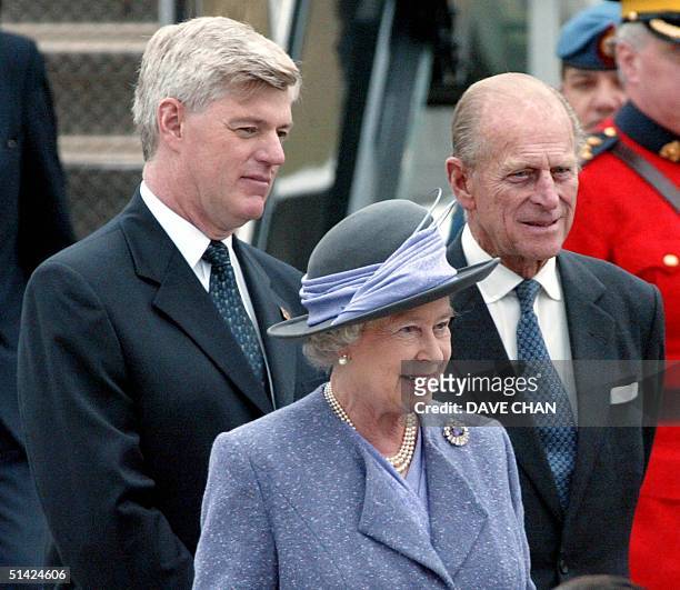 Britain's Queen Elizabeth II , Prince Philip and Canadian Deputy Prime Minister John Manley watch, 12 October 2002, during the arrival ceremony in...