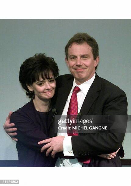 Number Ten Downing Street's new couple, Tony and Cherie Blair hug each other after addressing Labour party workers and supporters outside the Royal...