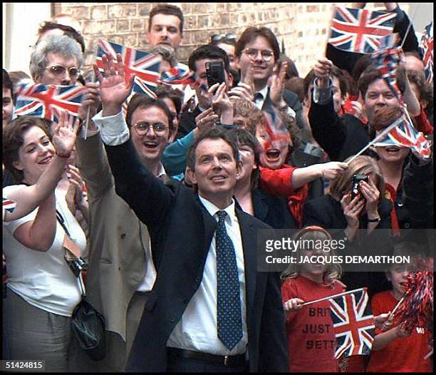 Newly elected British Prime Minister Tony Blair waves at supporters 02 May upon his arrival at No. 10 Downing Street in London, his new residence...