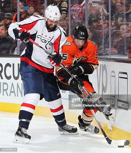 Mike Weber of the Washington Capitals and Mike Santorelli of the Anaheim Ducks vie for the puck on March 7, 2016 at Honda Center in Anaheim,...