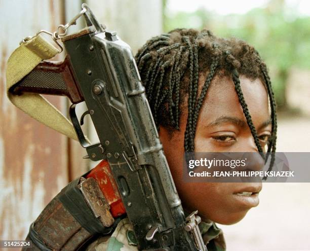 Picture dated 26 October 1997 shows a 15-year-old Congolese Cobra militiaman nicknamed "the Japanese" for his fast skills in combat, waiting 26...