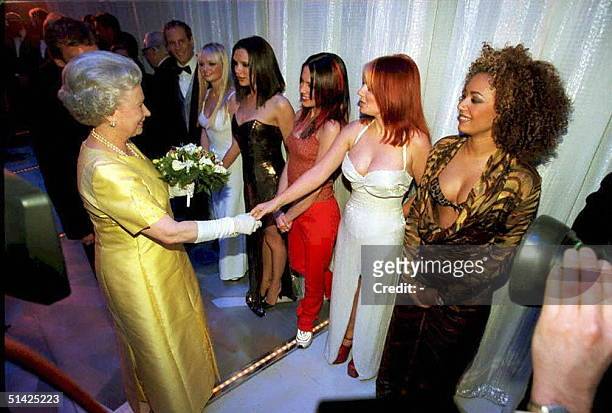 The Queen Elisabeth II shakes hands with Geri Halliwell of the pop group "Spice Girls" as Emma, Victoria, Mel C and Mel B look on, after 01 December...