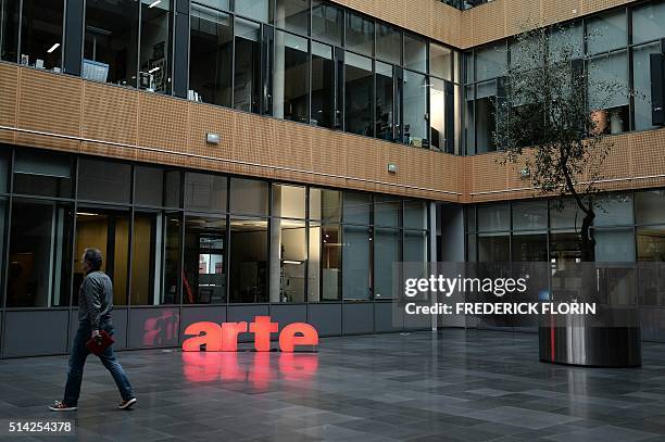 Man walks past the logo of public Franco-German TV network Arte in the courtyard of Arte in Strasbourg, eastern France, on March 1, 2016. Less...