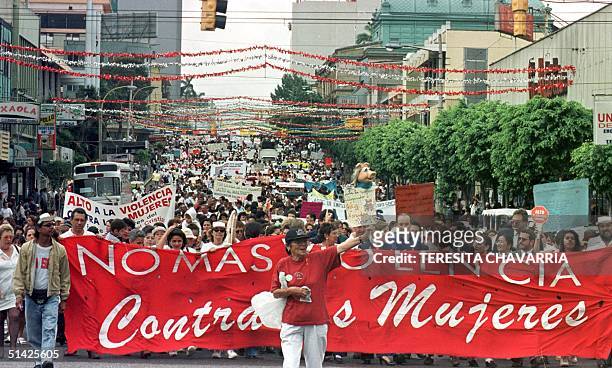Thousands of women march past carrying placards, 25 November, 1999 in San Jose, Costa Rica, during the march celebrated by the Day the International...