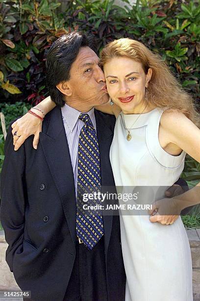 Peruvian presidential candidate Alexander Toledo of the opposition party known as Peru Possible kisses his wife, Eliane Karp 21 March 2000 in the...