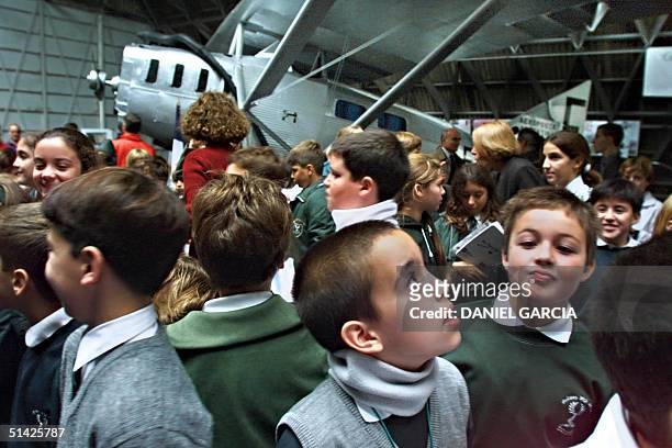 Children crowd around the French writer and pilot Antoine de Saint-Exupery's Latecoere 25 airplane in Buenos Aires 17 April 2000. The plane was used...