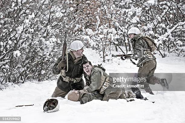 world war ii winter battlefield scene with soldier down - dead of world war ii stock pictures, royalty-free photos & images